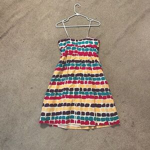 Strapless, knee length with adhesive at top to hold in place.